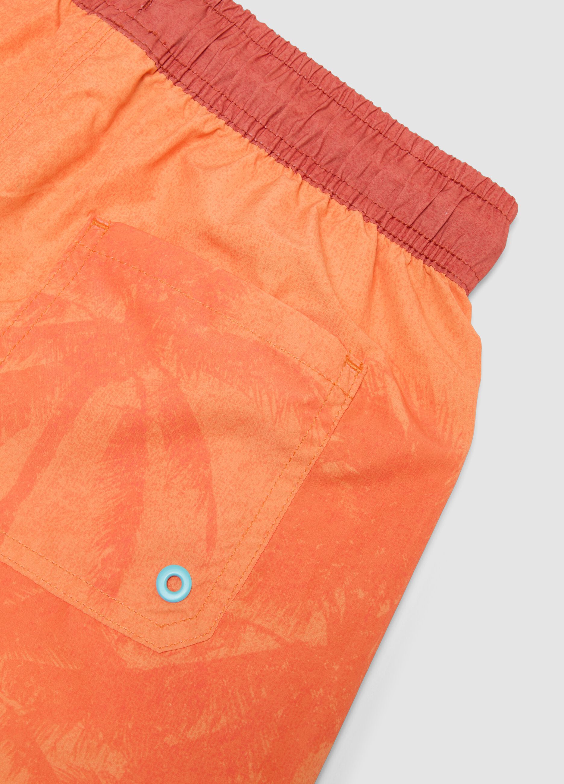 Orange boys&rsquo; swim shorts with tropical print
