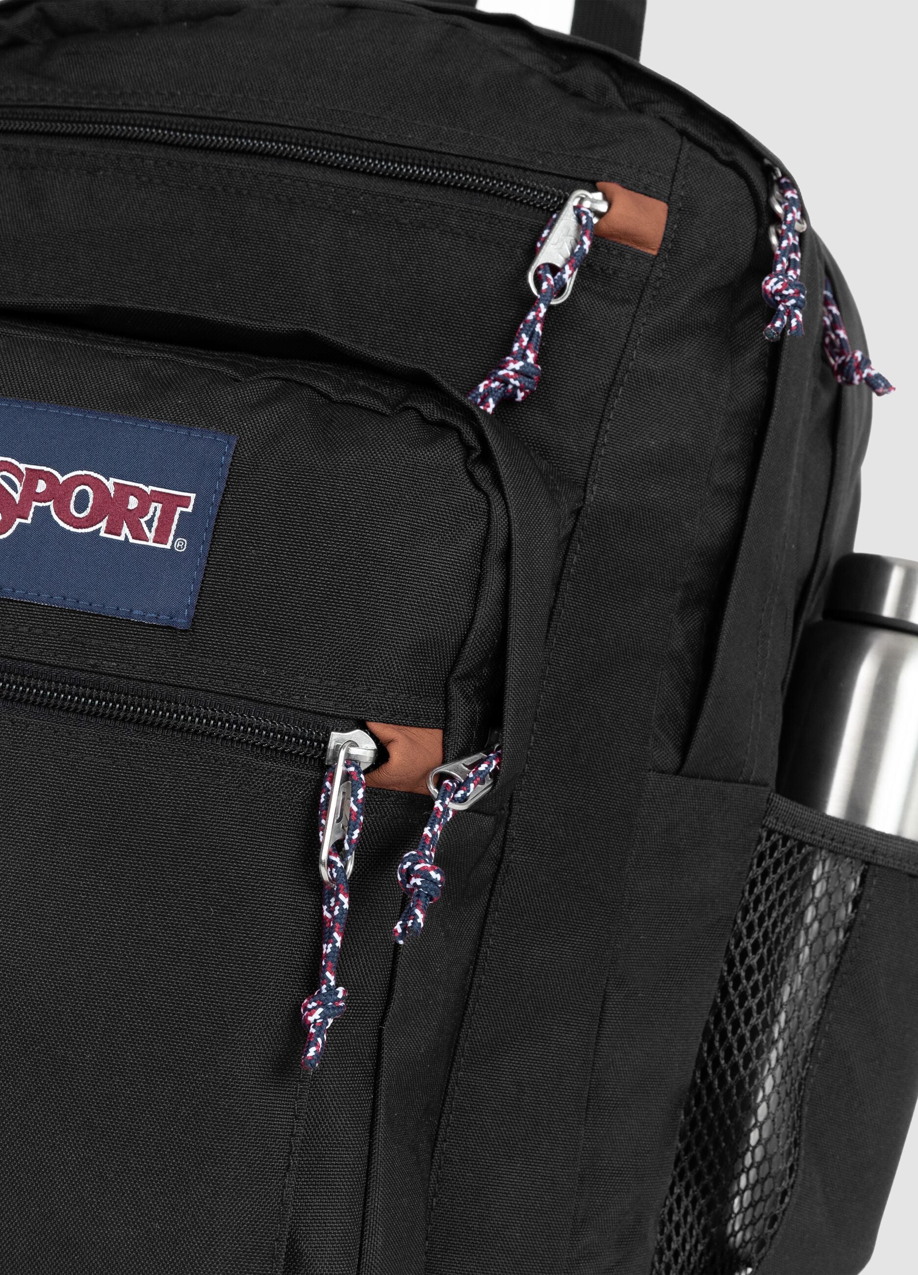 Black backpack with brown base and external pockets