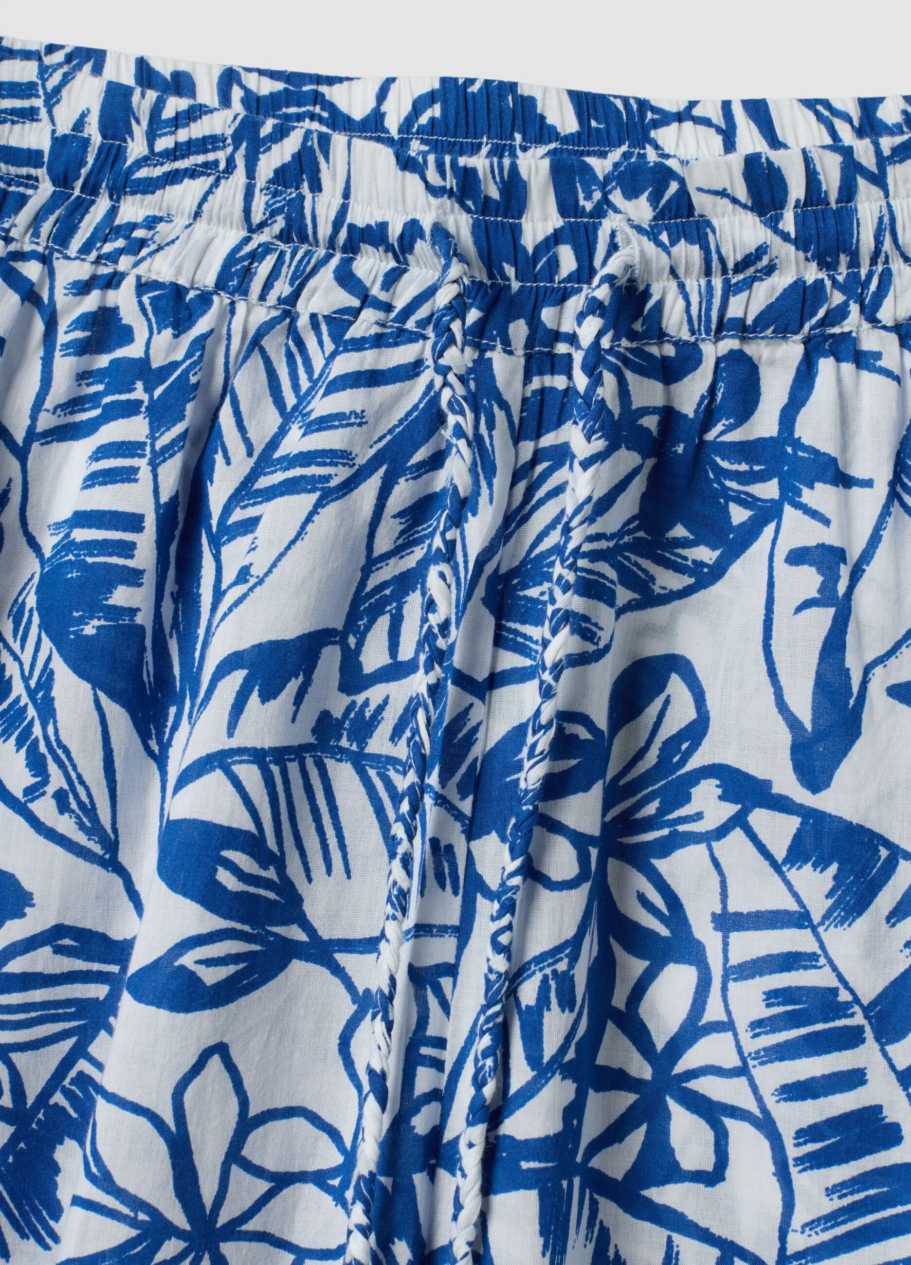 Blue and white organic cotton trousers with floral print