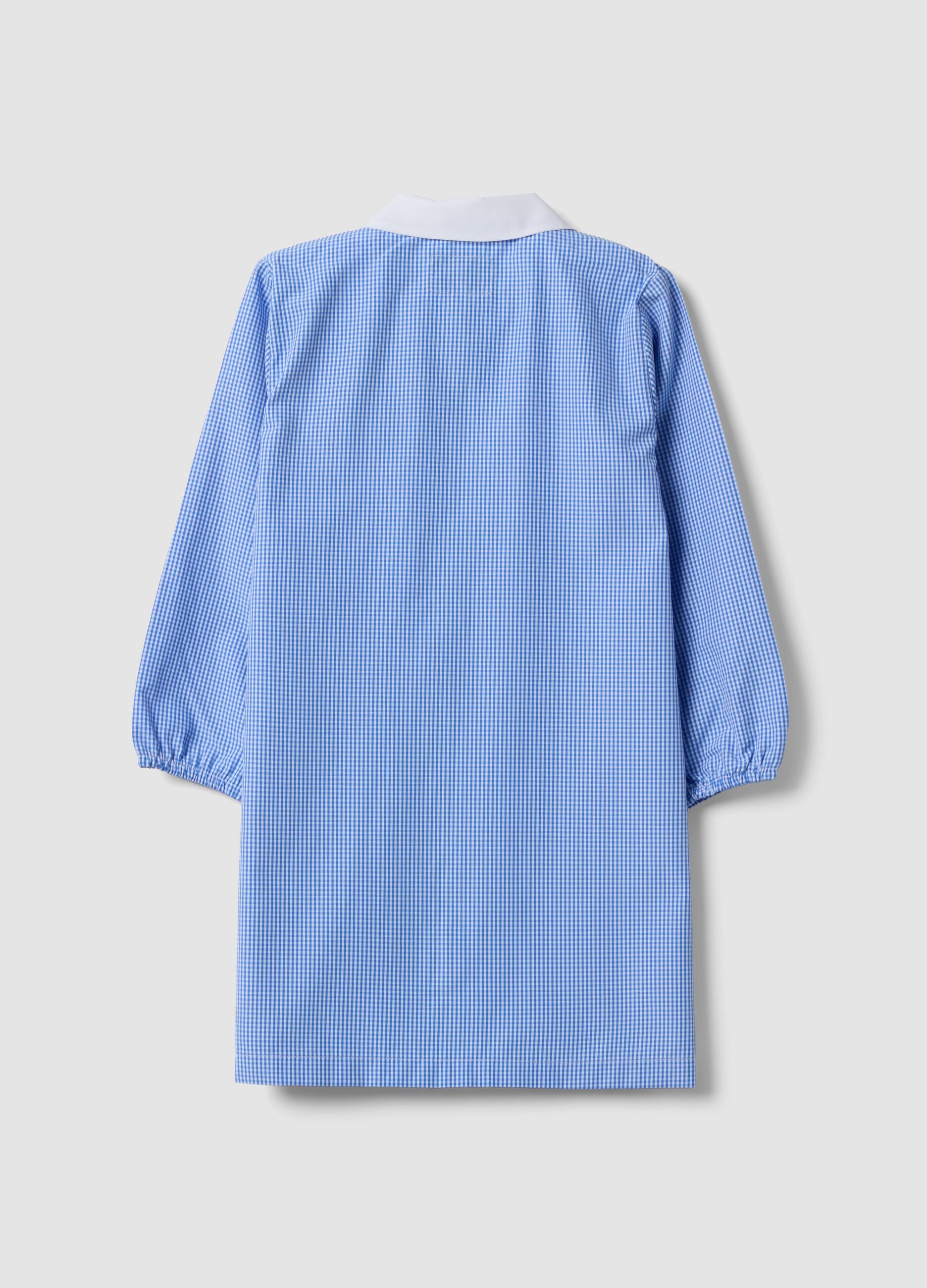 Customisable blue gingham nursery apron with machine embroidery