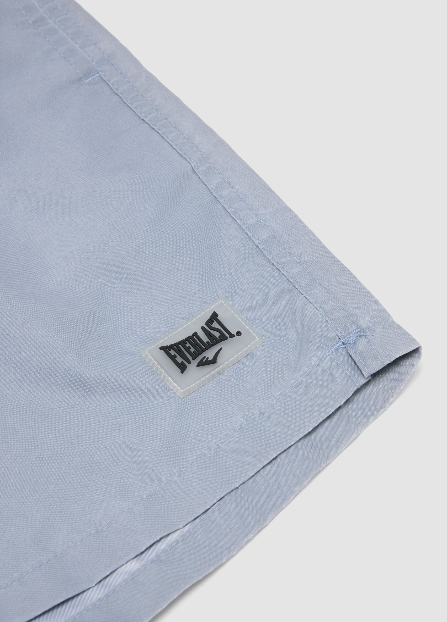 Blue swim shorts with drawstring waist