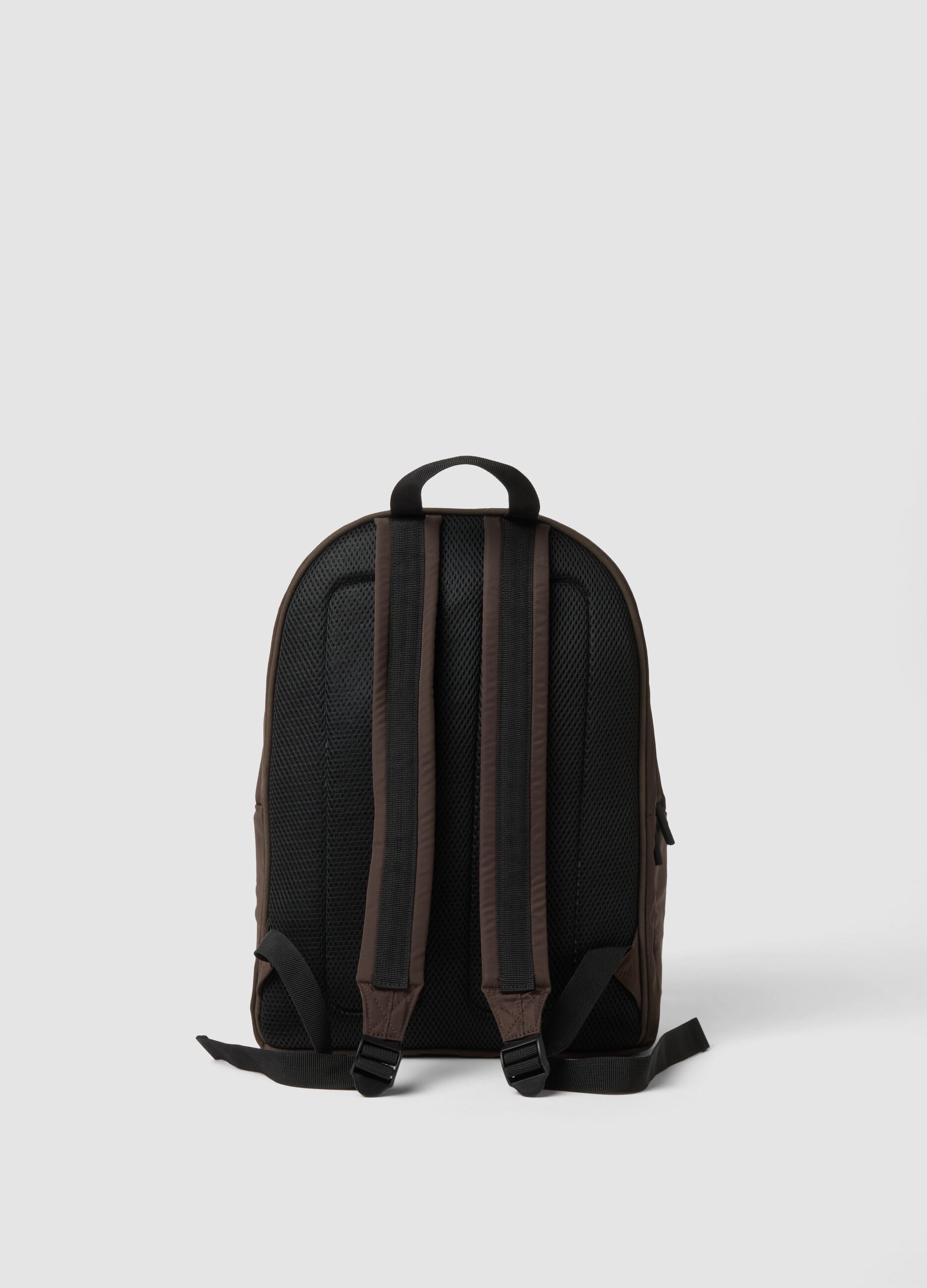 Brown backpack with front pocket and adjustable straps