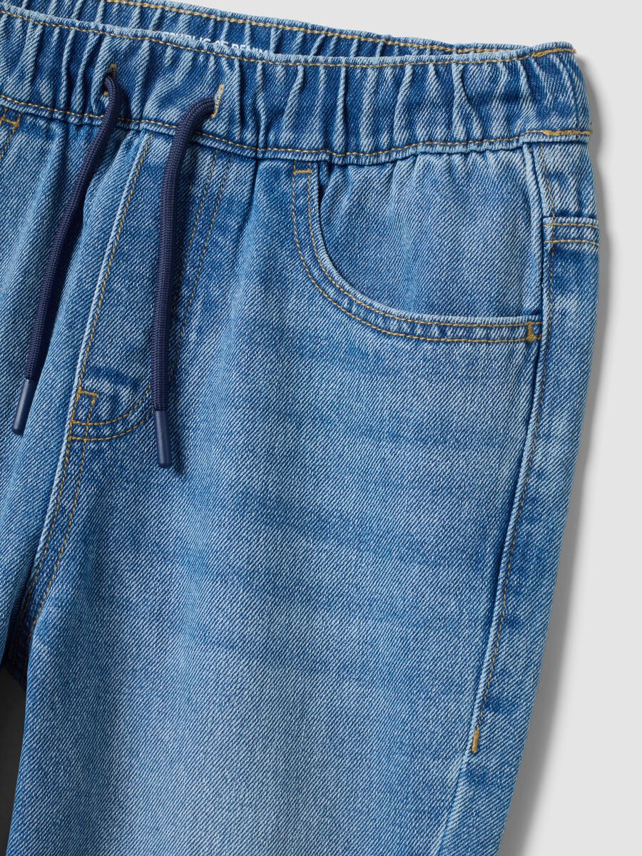 Blue denim jogger jeans in a cotton and viscose blend for boys_1