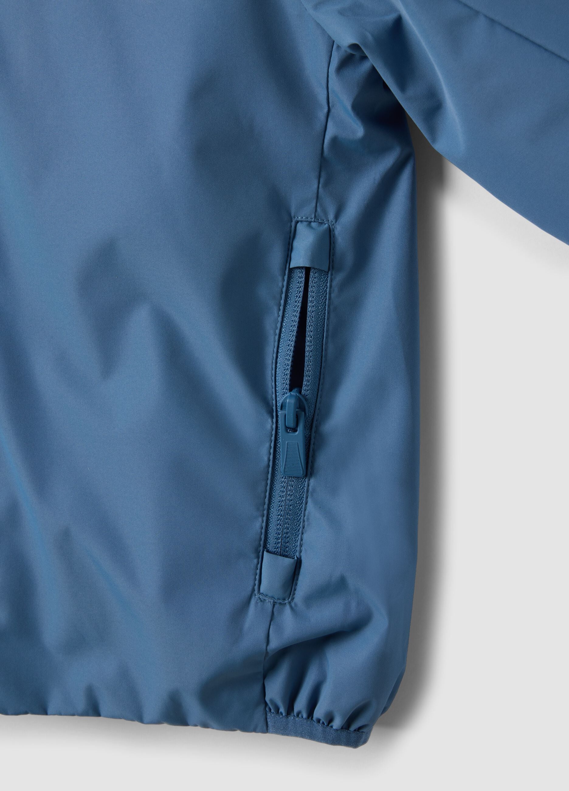Blue kids&rsquo; rain jacket with hood and zip
