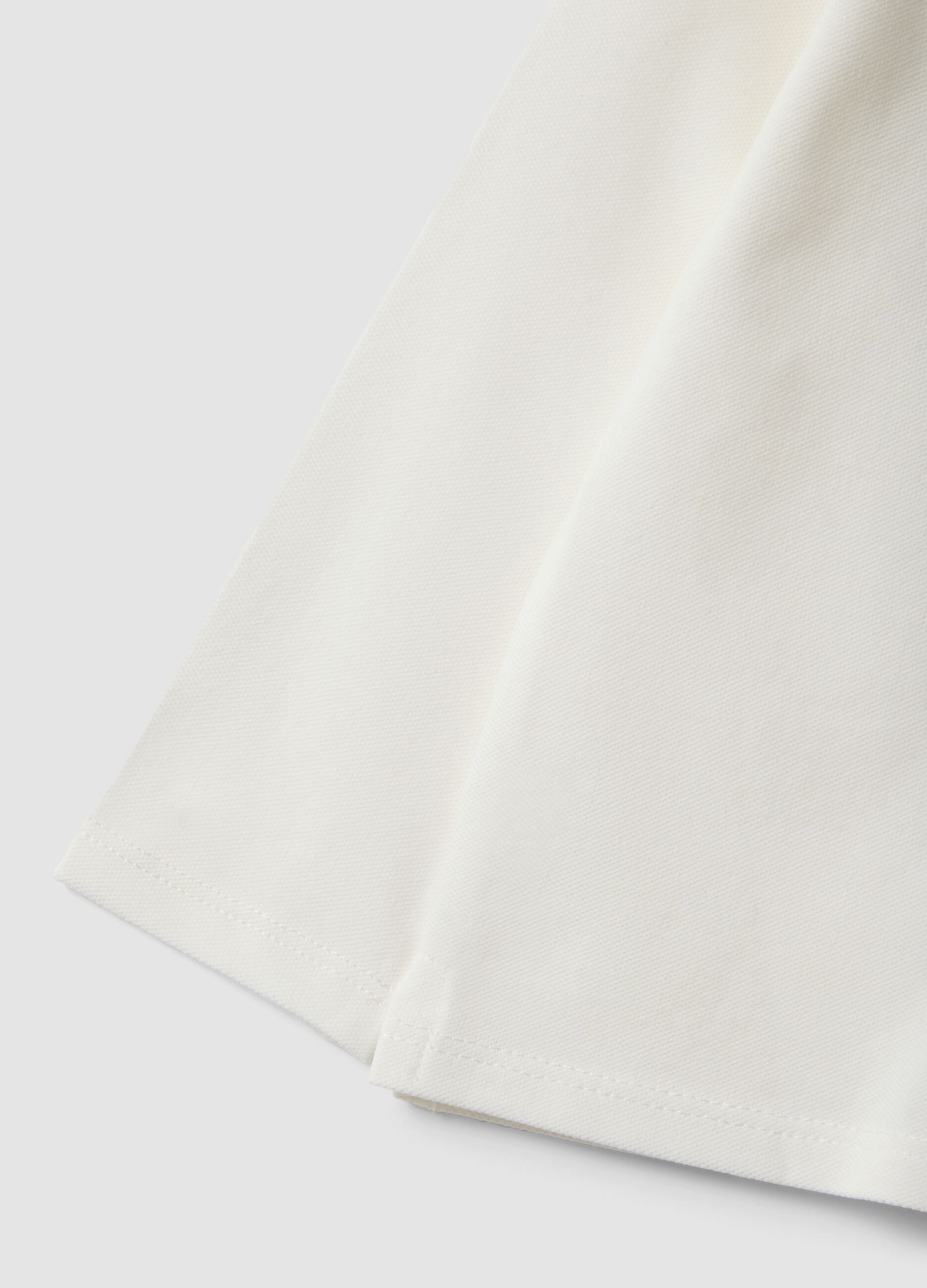 White stretch organic cotton polo shirt with ruffle detailing for baby girl