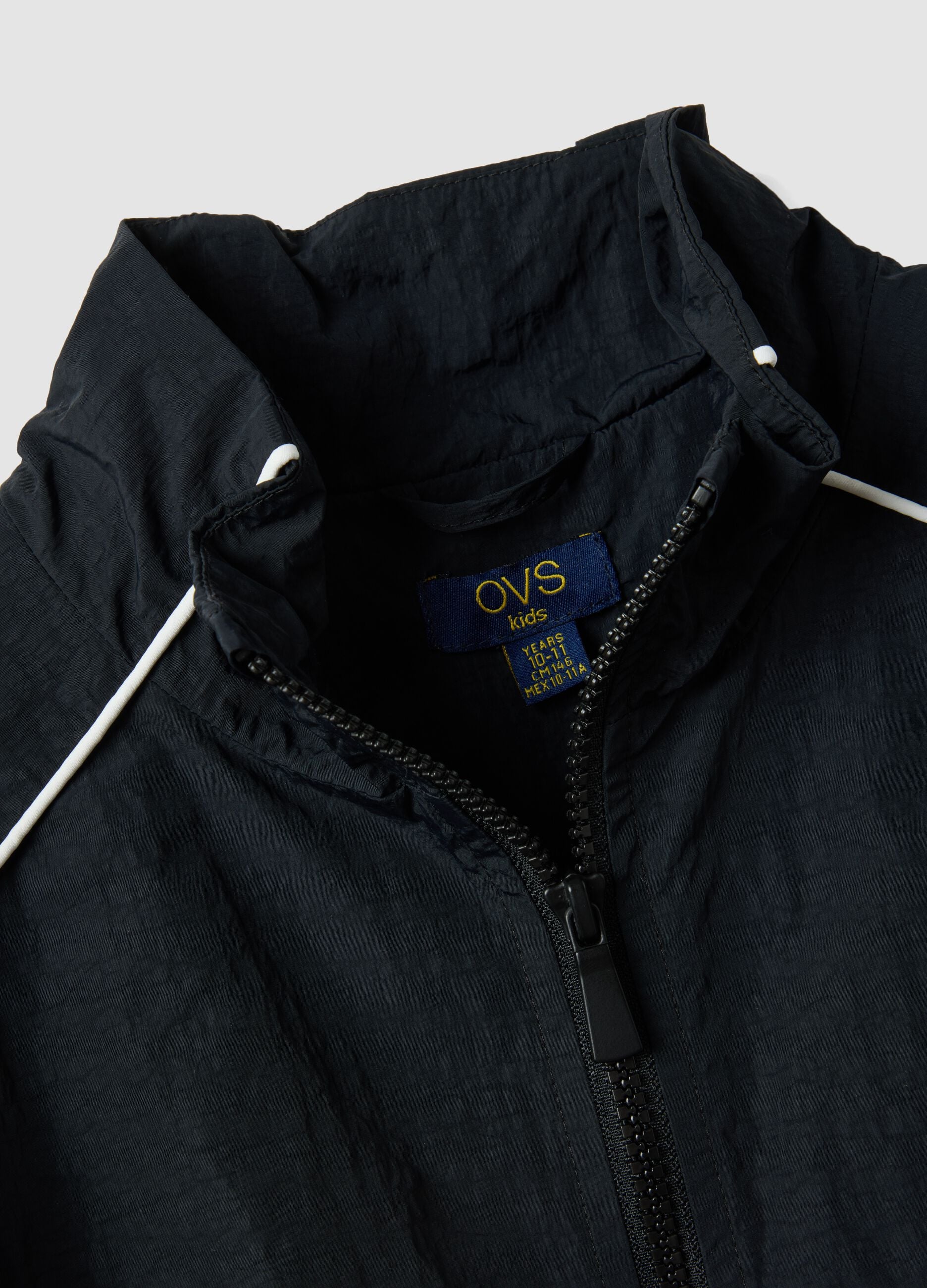 Black zip-up jacket with contrasting piping and high neck for girls