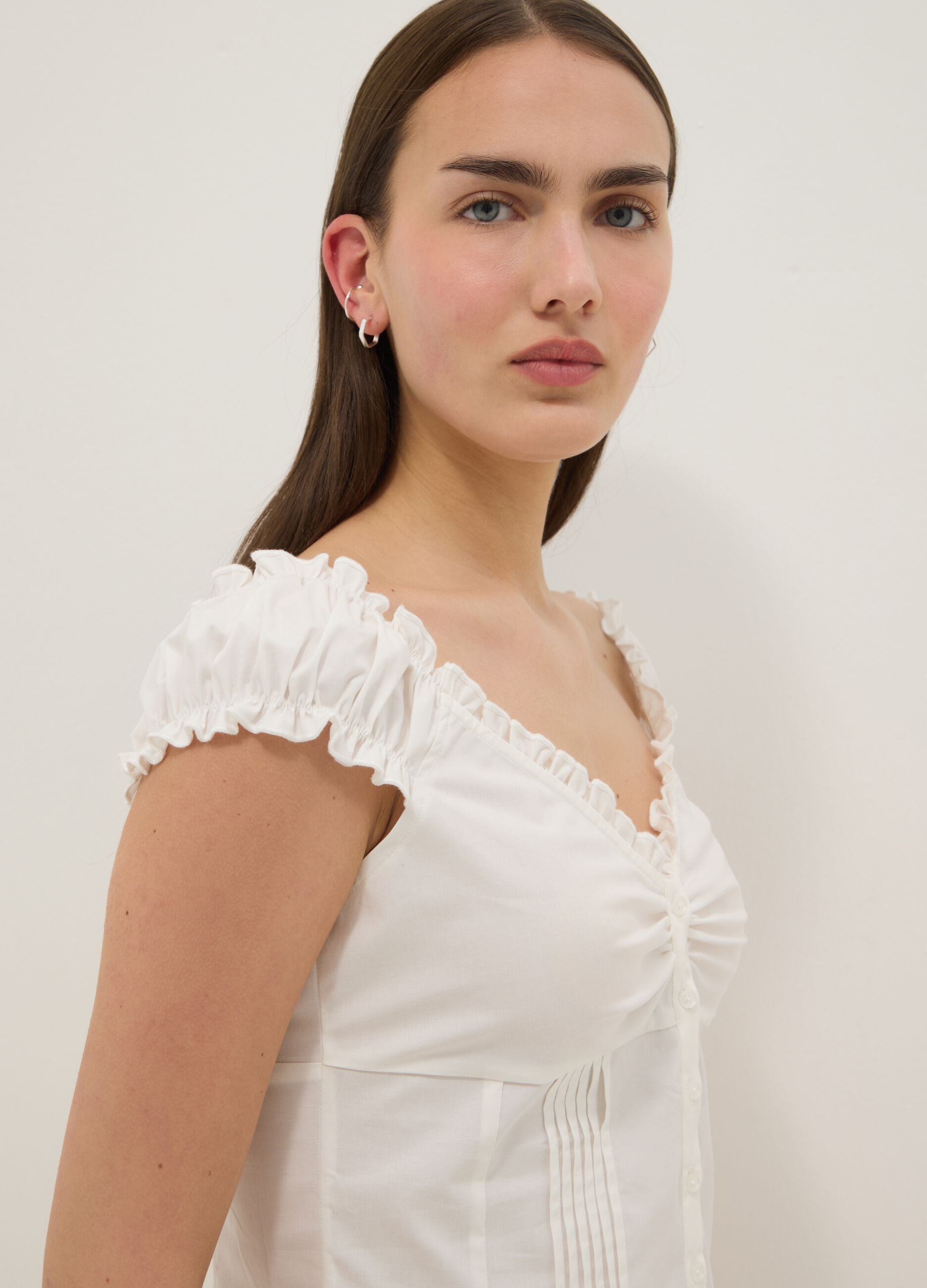 White stretch cotton blouse with buttons and ruffles, regular fit