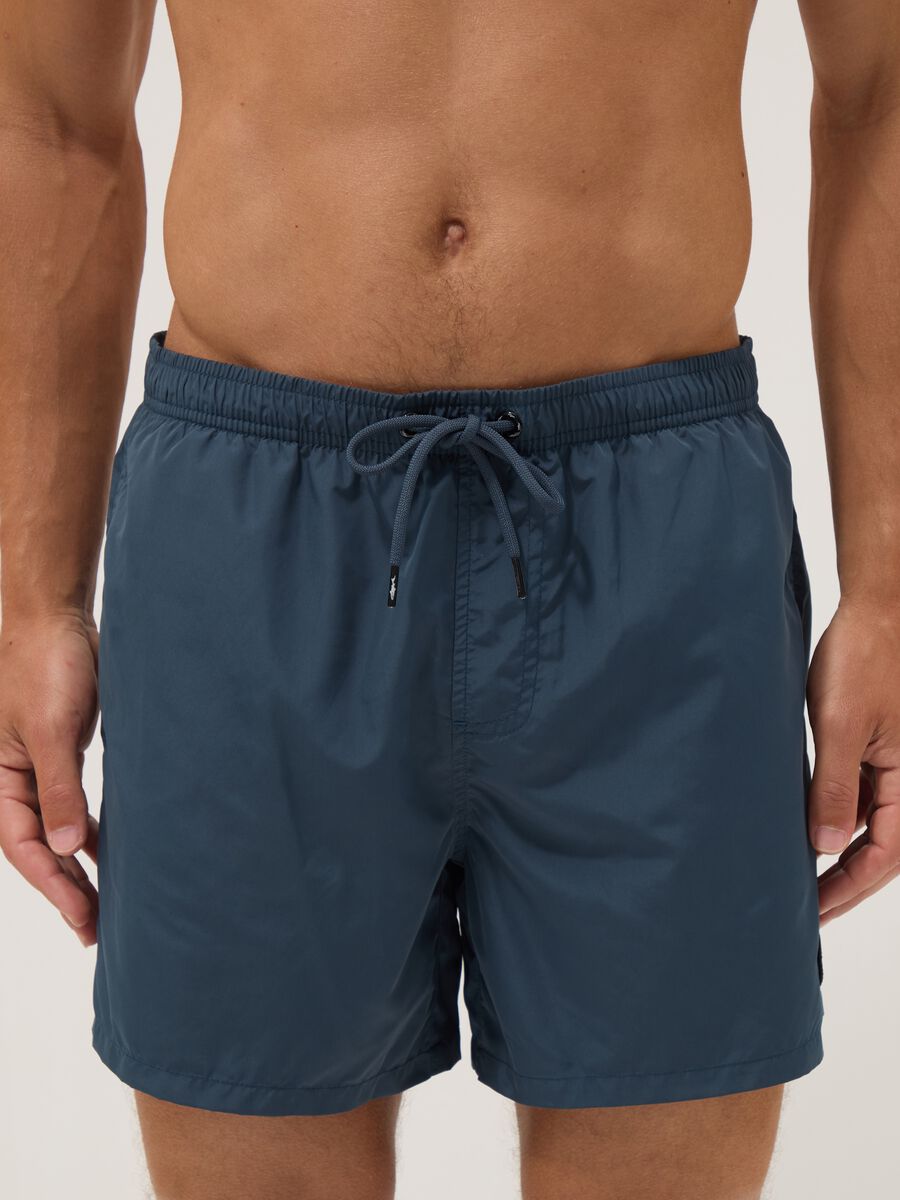 Blue swim shorts with elasticated waistband and drawstring_1