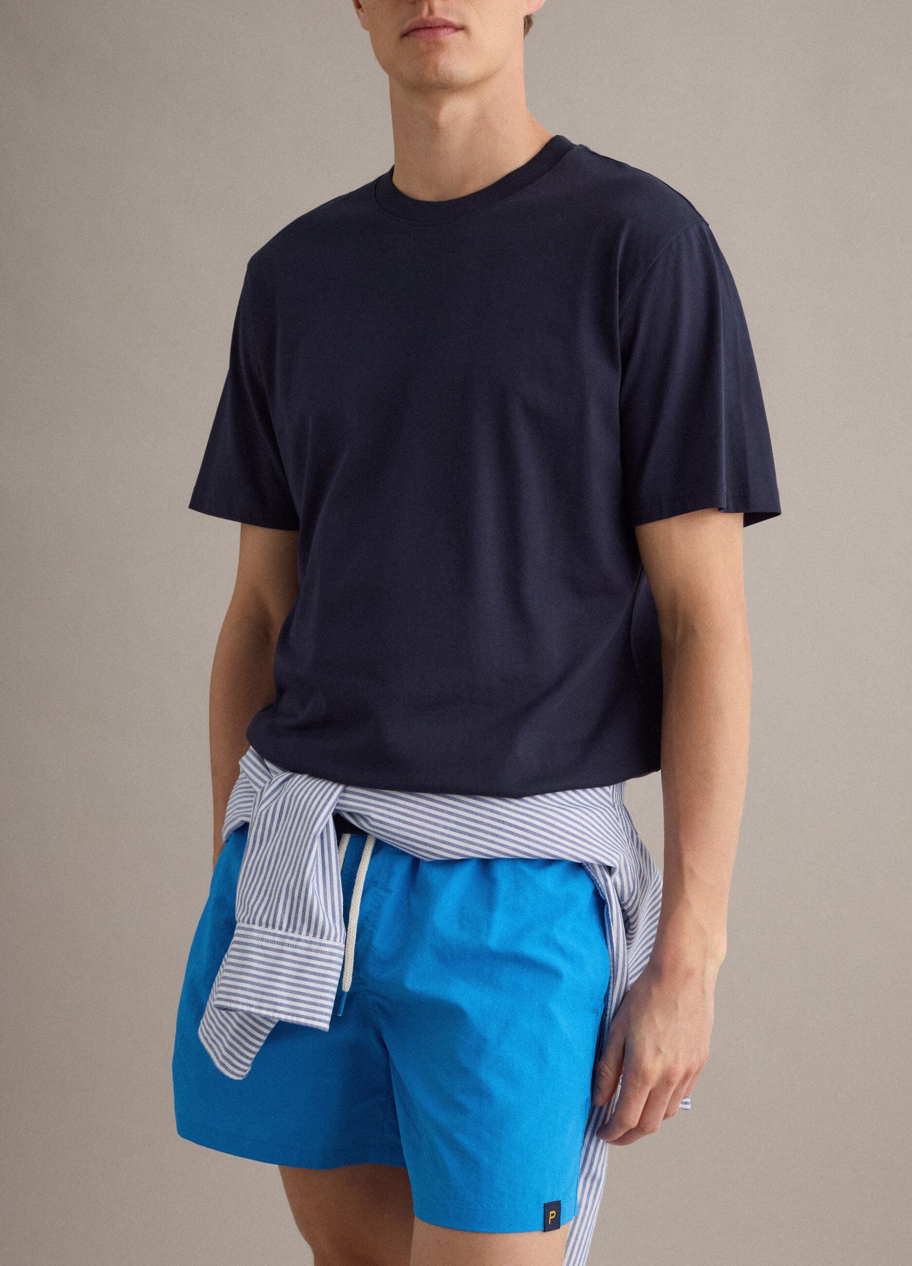 Blue swim shorts with elasticated waistband and contrast drawstring