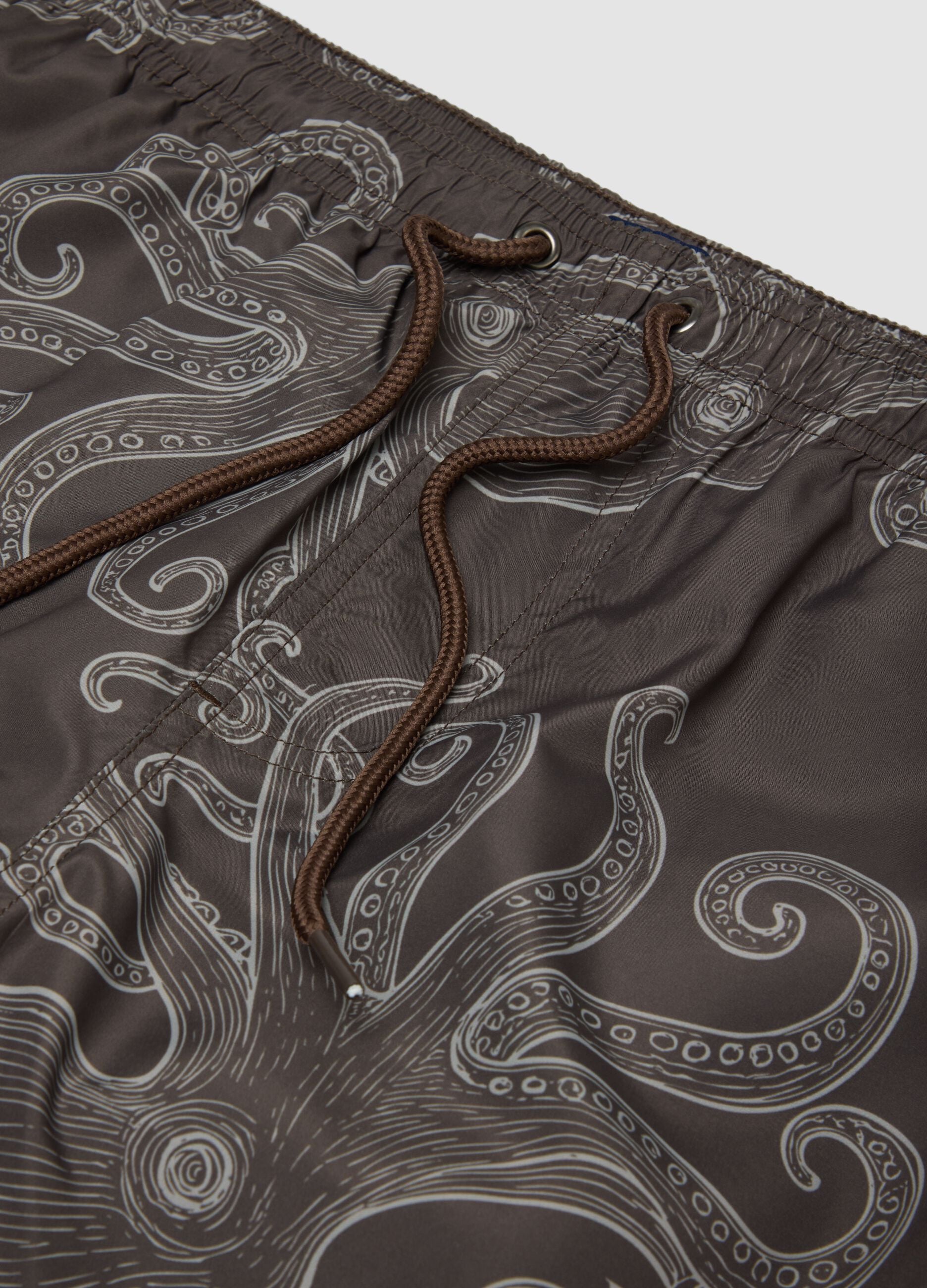 Brown swim shorts with all-over print