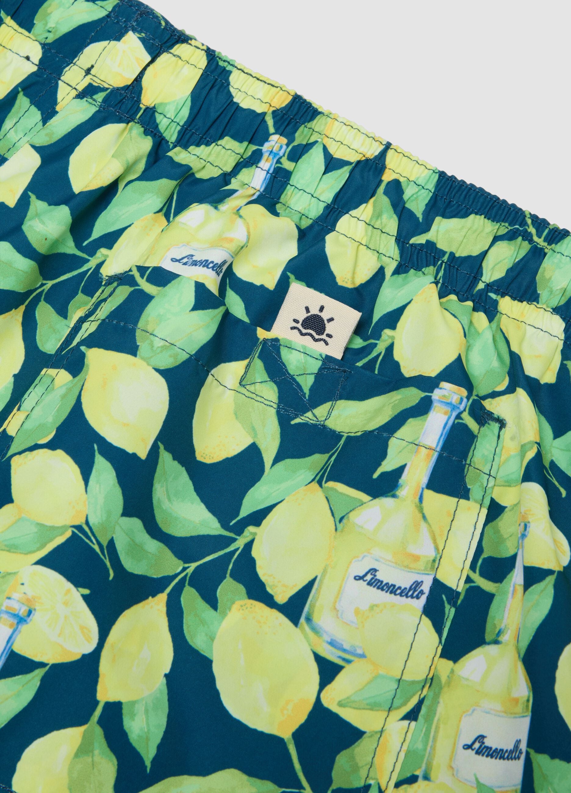 Blue boxer swim shorts with Limoncello print