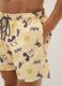 Orange swim trunks with Mickey Mouse prints_3