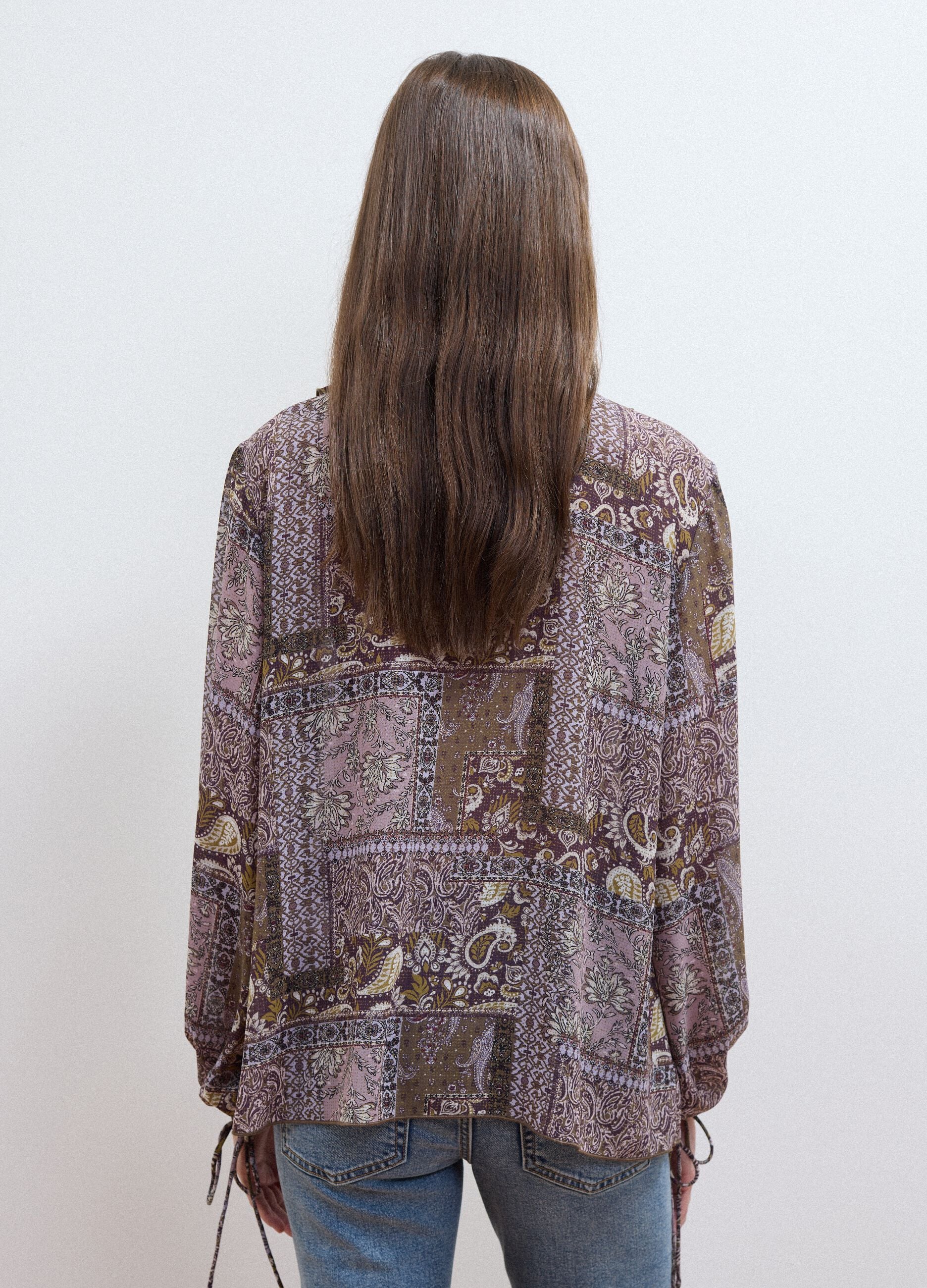 Purple patterned blouse with ruffles and tie neck