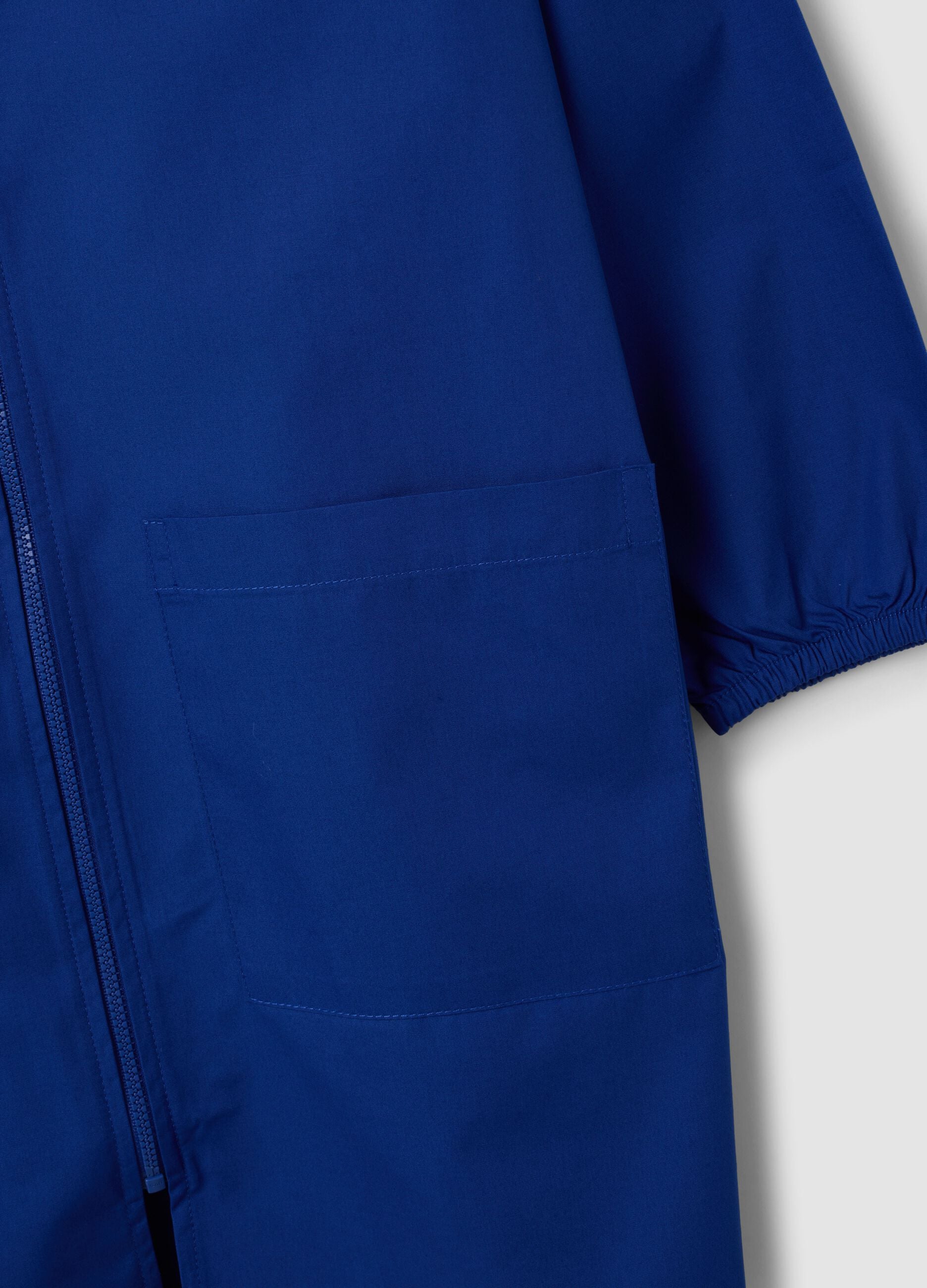 Customisable blue school apron with zip and kart embroidery