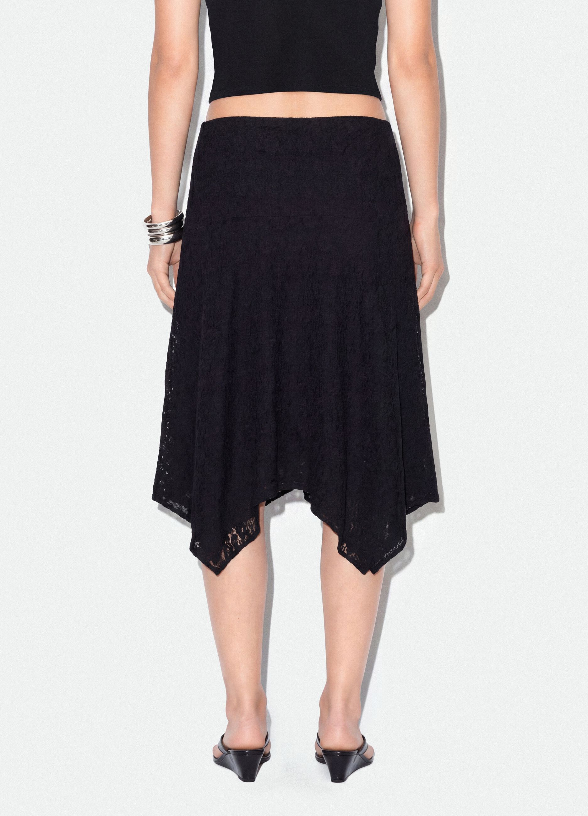 Black stretch-fabric skirt with asymmetric lace hem