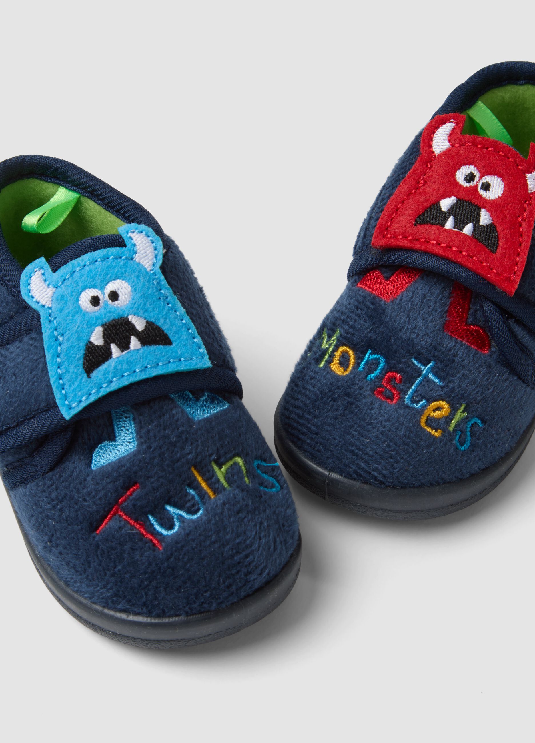 Blue slippers with embroidered monsters