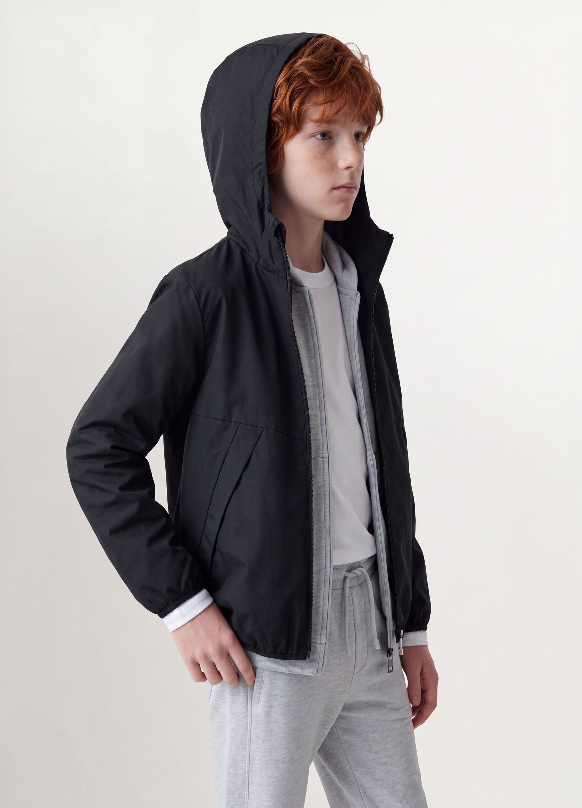 Black oversized rain jacket with hood and zip for boys