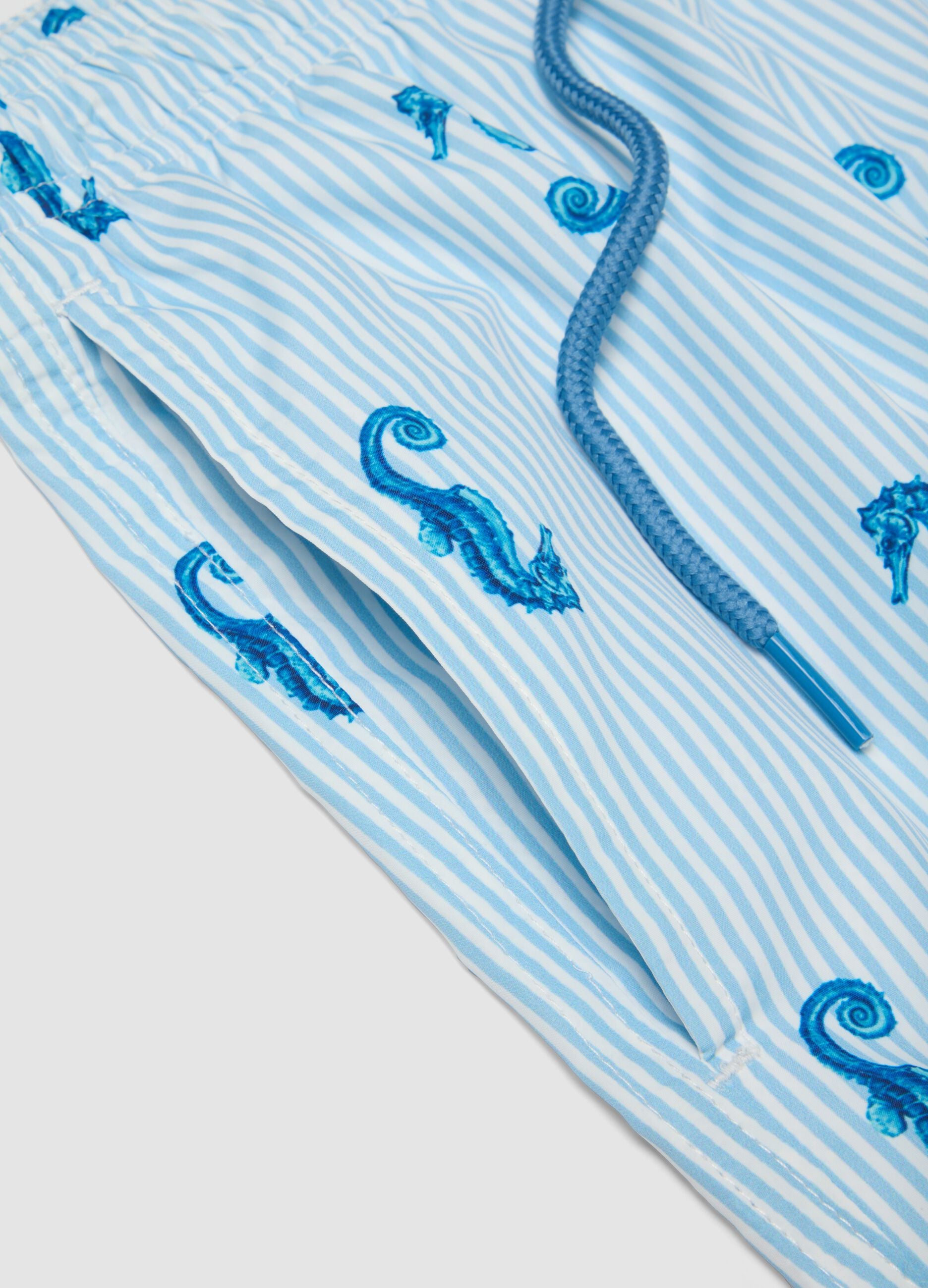 Blue striped swim shorts with seahorse print