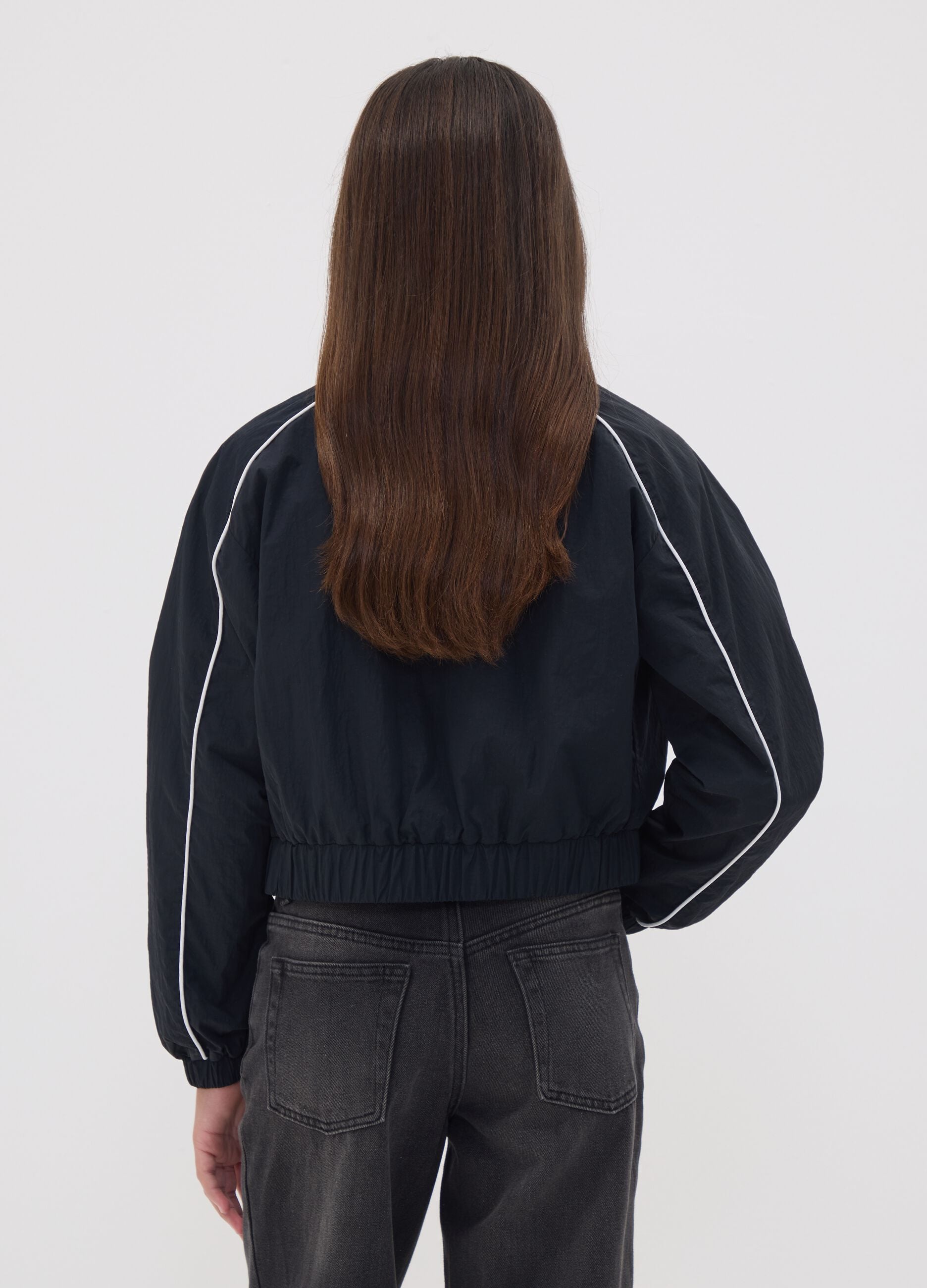Black zip-up jacket with contrasting piping and high neck for girls