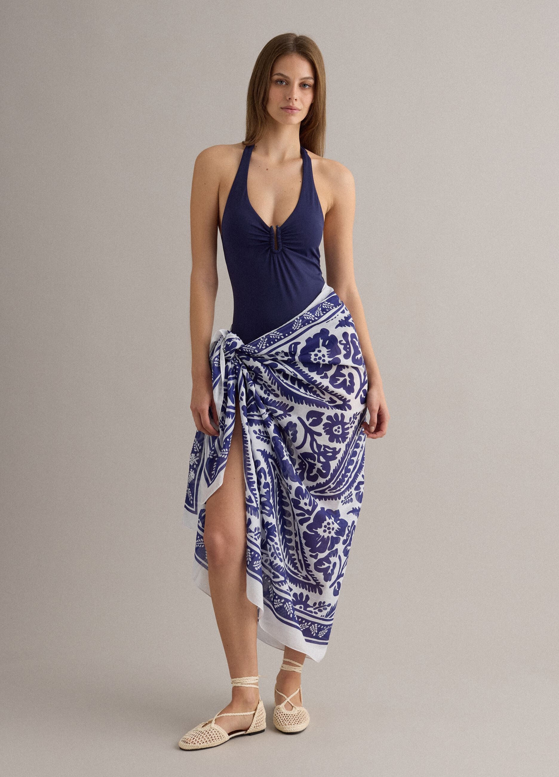 Blue stretch fabric swimsuit with halterneck ties