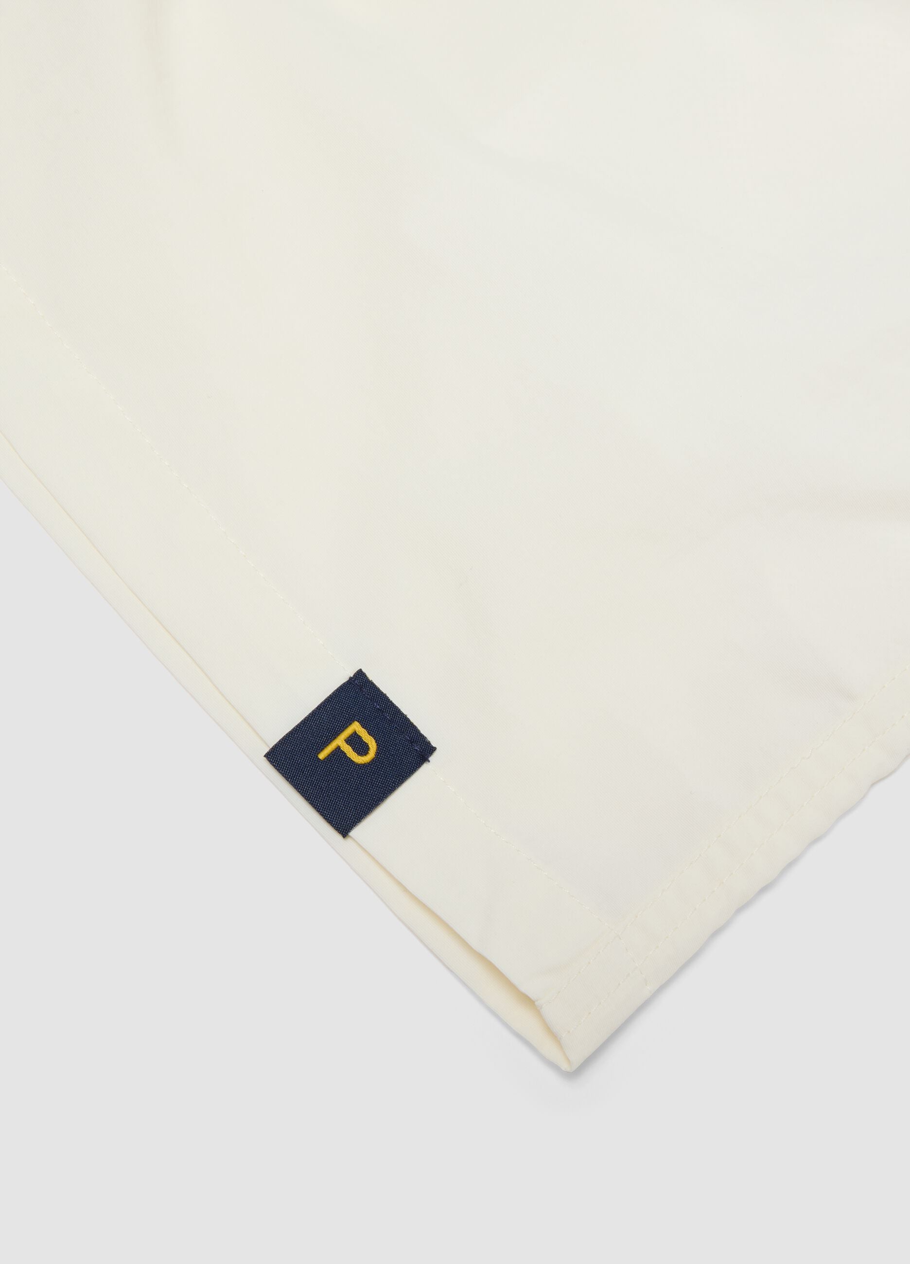 White swim shorts with elasticated waistband and drawstring