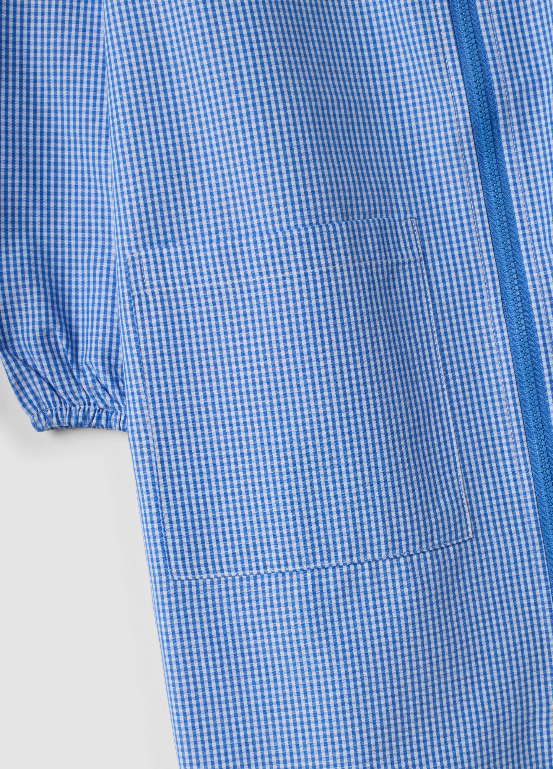 Customisable blue gingham nursery apron with machine embroidery