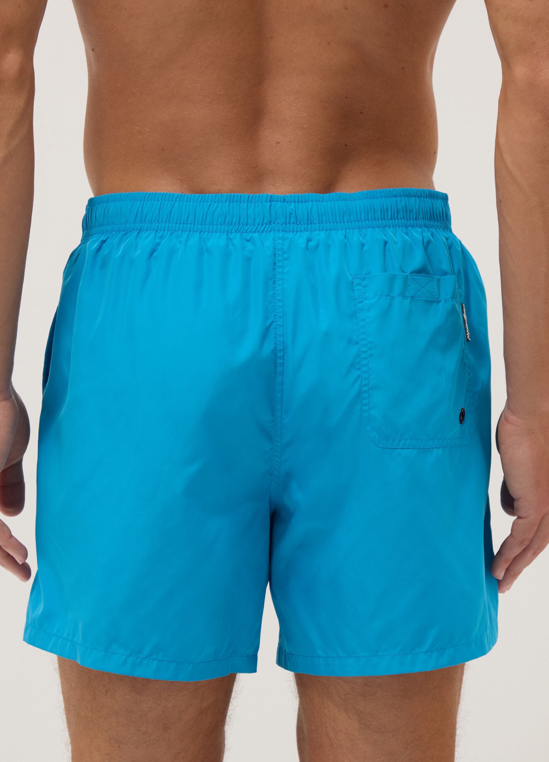 Blue swim shorts with elasticated waist and drawstring